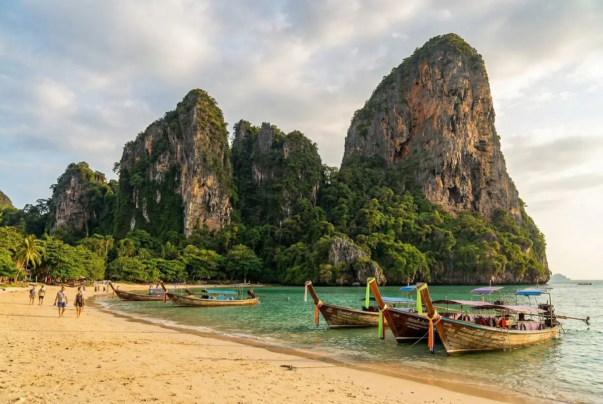 Limestone cliffs and long-tail boats on Railay Beach in Krabi
